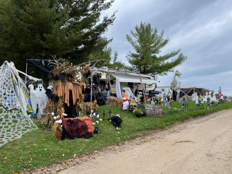 People gathered at a decorated car campsite