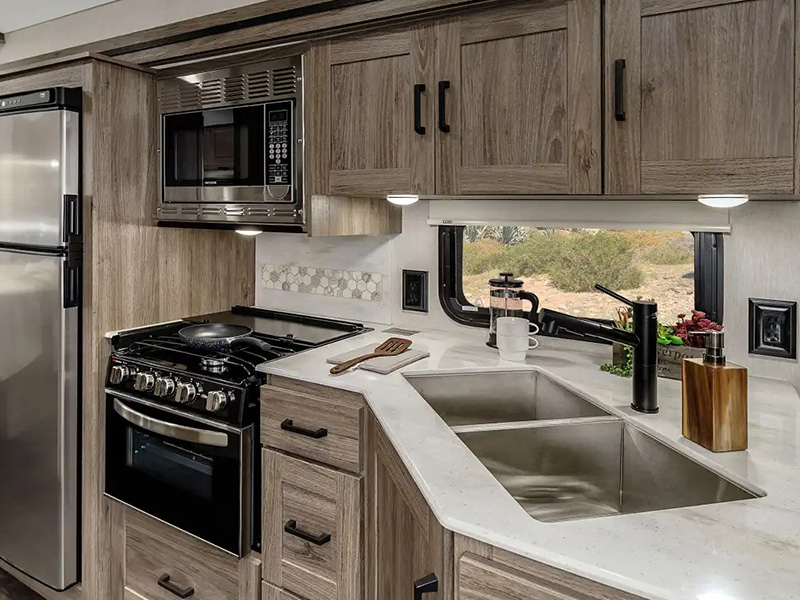 Modern car kitchen interior with wood cabinets and counter space